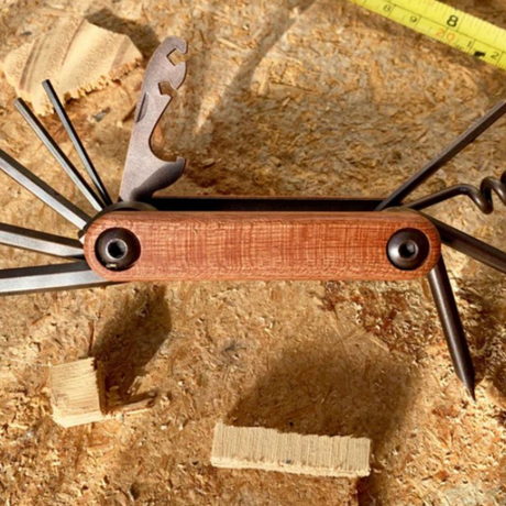 Multi-functional tool for builders, cyclists, and DIY-ers with 12 features including a bottle opener and spoke wrench.